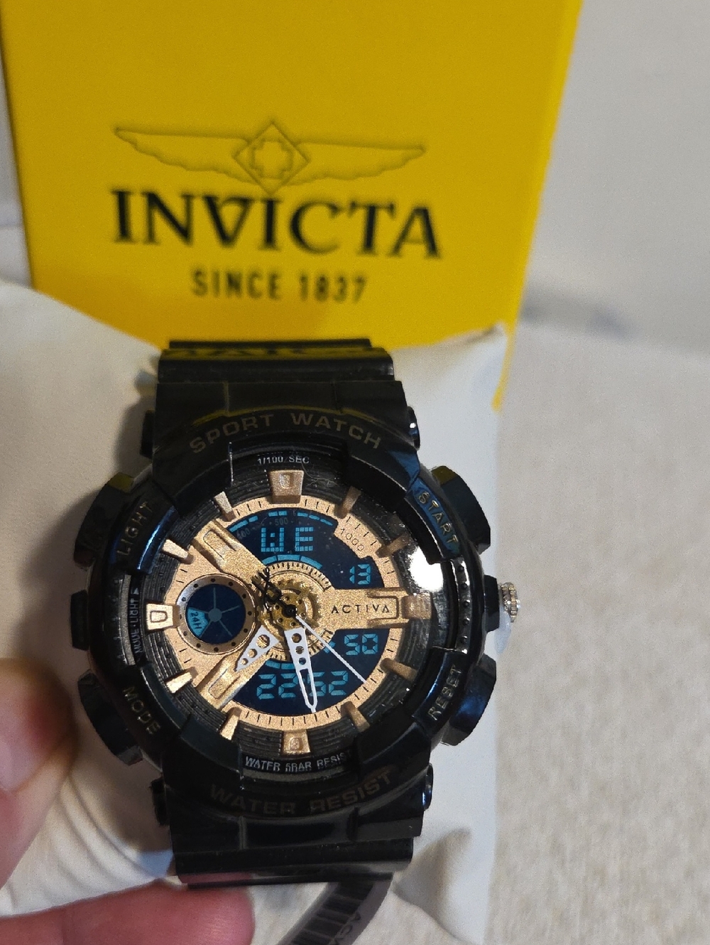 Invicta Black and Gold Men's Sport Watch with Blue Accents